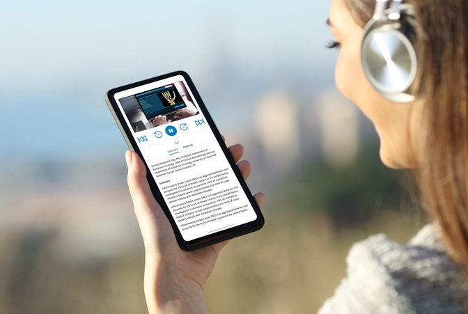 Woman in headphones outdoors holding mobile phone displaying app screen